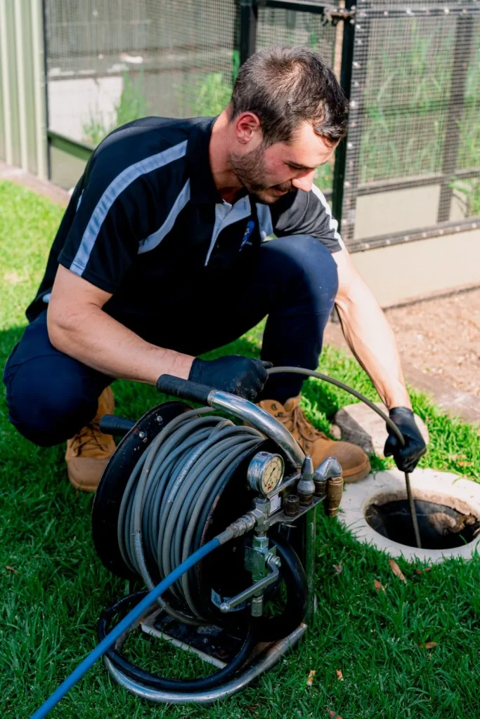 Emergency plumber clearing a blocked drain